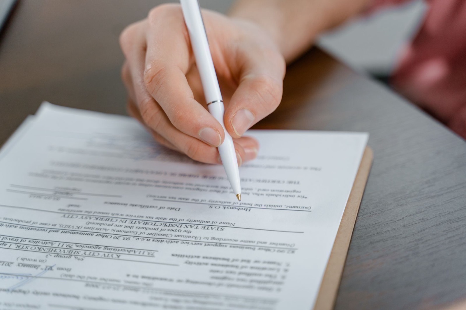 A bound share purchase agreement and its signature page on a desk.