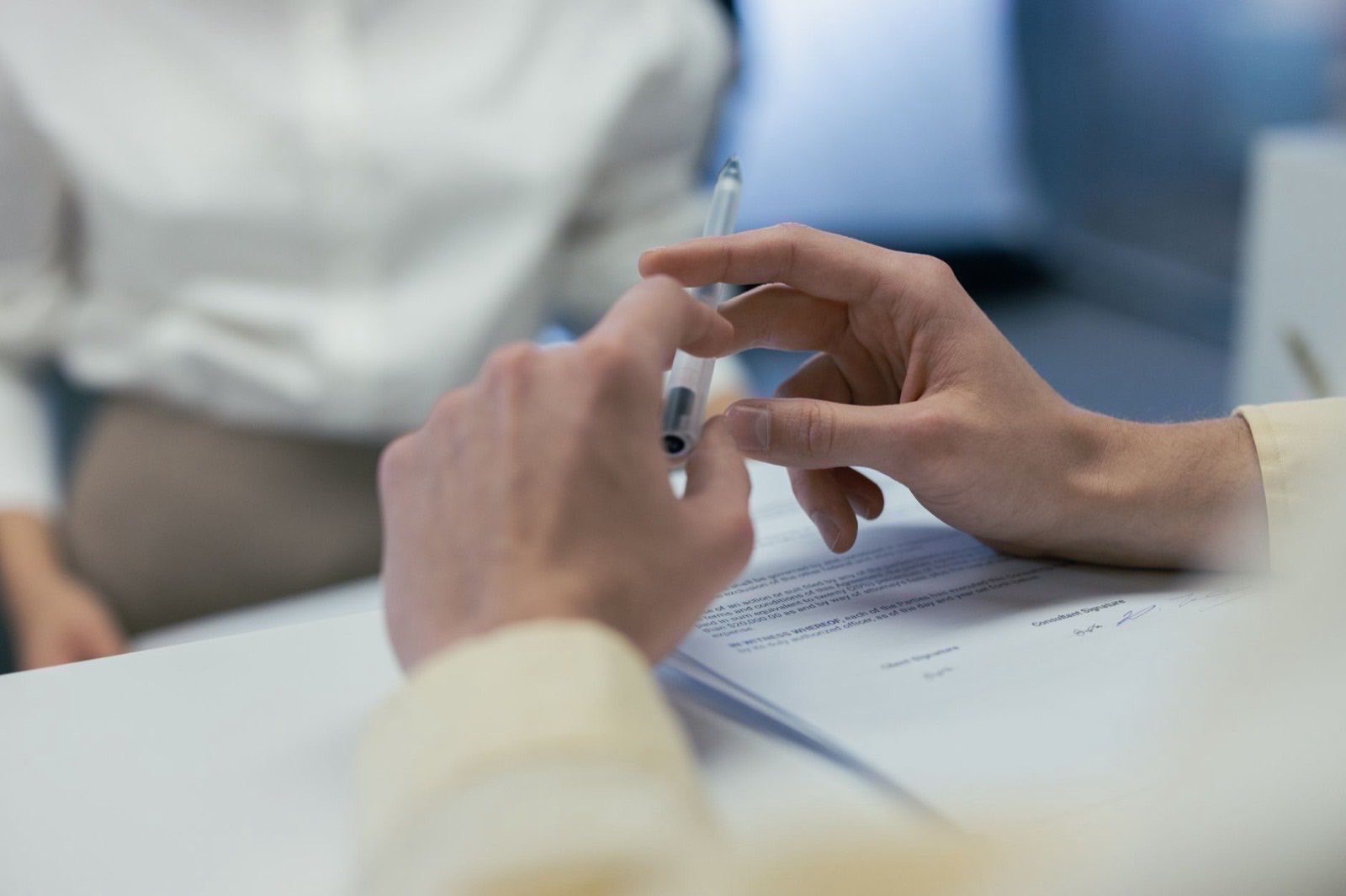 A bound notarial deed and a certified translation on a desk before signature.